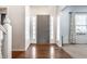 Inviting foyer featuring hardwood floors, a front door, sidelights and neutral wall color at 9239 Stones Ferry Way, Indianapolis, IN 46278