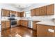 Well-equipped kitchen with stainless steel appliances, wood cabinets, and tiled backsplash at 9239 Stones Ferry Way, Indianapolis, IN 46278