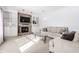 Inviting living room with a brick fireplace, built-in shelving, and comfortable neutral sofa at 9239 Stones Ferry Way, Indianapolis, IN 46278