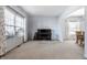 Spacious living room with neutral tones, large windows and a black piano at 9239 Stones Ferry Way, Indianapolis, IN 46278