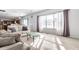 Bright and open living room featuring hardwood floors and natural light, open to the kitchen at 9239 Stones Ferry Way, Indianapolis, IN 46278