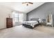 Well-lit main bedroom with a high ceiling, light carpet, and neutral decor at 9239 Stones Ferry Way, Indianapolis, IN 46278