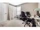 A home office with plush desk chair, window, a desk and white door at 9239 Stones Ferry Way, Indianapolis, IN 46278