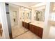 Bathroom featuring double sinks and mirrored closet at 9523 Maple Way, Indianapolis, IN 46268