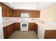 Traditional eat-in kitchen with white appliances and wood cabinets at 9523 Maple Way, Indianapolis, IN 46268