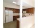 Functional kitchen featuring classic wood cabinetry and essential white appliances at 9523 Maple Way, Indianapolis, IN 46268