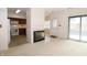 Open-concept living area with fireplace, adjacent kitchen with appliances and a bright, airy feel at 9523 Maple Way, Indianapolis, IN 46268