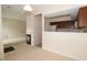 Open-concept living space with a fireplace, transitioning into a kitchen area with wood cabinetry at 9523 Maple Way, Indianapolis, IN 46268
