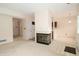 Spacious open-concept living area with a fireplace, next to a functional kitchen with white appliances at 9523 Maple Way, Indianapolis, IN 46268