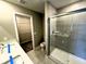 Bathroom featuring a double vanity, tiled floors, and glass enclosed shower at 9634 Beckett St, Avon, IN 46123