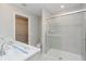 A modern bathroom featuring double sinks, quartz countertops and a glass-enclosed shower at 9634 Beckett St, Avon, IN 46123