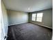Spacious bedroom featuring a large window, neutral paint, and soft carpeting at 9634 Beckett St, Avon, IN 46123