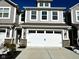 Beautiful exterior elevation view of a gray townhome with an attached two-car garage and a concrete driveway at 9634 Beckett St, Avon, IN 46123