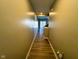 View of a long hallway with wood floors leading to a staircase and back doorway with ample natural light at 9634 Beckett St, Avon, IN 46123