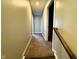 Hallway with carpet and neutral paint leading to the bedrooms and bathrooms at 9634 Beckett St, Avon, IN 46123