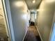 Carpeted hallway with neutral paint and closet access leading to stairs at 9634 Beckett St, Avon, IN 46123