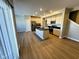 Bright kitchen featuring a large island with a sink, modern appliances, and light wood-look flooring at 9634 Beckett St, Avon, IN 46123