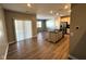 Open concept view of the kitchen, dining, and living area with stainless steel appliances and wood flooring at 9634 Beckett St, Avon, IN 46123