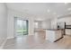 Open concept living room with sliding glass doors leading to patio and seamless flow to kitchen at 9634 Beckett St, Avon, IN 46123