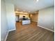 Open-concept living space seamlessly connecting the kitchen, dining area, and living room with wood flooring at 9634 Beckett St, Avon, IN 46123