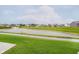 Scenic view of the neighborhood pond with water features amid lush green lawns and neighborhood houses at 9634 Beckett St, Avon, IN 46123