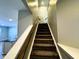 Carpeted staircase with wooden handrail ascending to the upper level of the home near the kitchen at 9634 Beckett St, Avon, IN 46123