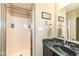 Featuring a glass-enclosed shower, dark vanity, and warm lighting, this bathroom provides a spa-like experience at 1058 W Limestone Way, Fortville, IN 46040