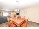 Cozy dining area with a wooden table, seamlessly connecting to the living room and kitchen at 1058 W Limestone Way, Fortville, IN 46040