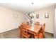 Cozy dining room featuring a wooden table with chairs, lit by a charming chandelier at 1058 W Limestone Way, Fortville, IN 46040