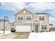 Charming two-story home with light brick and tan siding, complemented by a well-maintained yard and two-car garage at 1058 W Limestone Way, Fortville, IN 46040