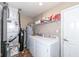 Bright laundry room with a washer, dryer, water heater, and utility sink at 1058 W Limestone Way, Fortville, IN 46040