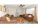 Relax in this living room with its plush sofas, natural light, and a ceiling fan for added comfort at 1058 W Limestone Way, Fortville, IN 46040