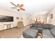 Inviting living room featuring plush furniture, a ceiling fan, and views into the dining area and stairway at 1058 W Limestone Way, Fortville, IN 46040