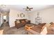 Cozy living room features brown couches, decorative shelving, and a ceiling fan at 1058 W Limestone Way, Fortville, IN 46040