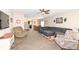 Spacious living room with comfortable seating and a ceiling fan, open to the dining area and kitchen at 1058 W Limestone Way, Fortville, IN 46040