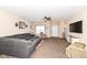Open living room boasts a large sectional sofa, a ceiling fan, and ample natural light at 1058 W Limestone Way, Fortville, IN 46040