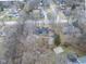 Overhead view highlights a home with mature trees, and proximity to neighborhood amenities at 11035 W Lakeshore Dr, Carmel, IN 46033