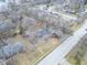 An aerial shot captures the house nestled among mature trees in a residential neighborhood setting at 11035 W Lakeshore Dr, Carmel, IN 46033