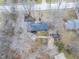 An aerial shot of a well-kept home with a landscaped yard, a shed, a sports court, and mature trees at 11035 W Lakeshore Dr, Carmel, IN 46033