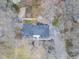 An aerial view displays the home's roof, driveway, and surrounding leafless trees at 11035 W Lakeshore Dr, Carmel, IN 46033