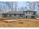 Exterior shot of a house showing a backyard with a patio and view of the well-maintained gray home at 11035 W Lakeshore Dr, Carmel, IN 46033