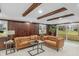 Inviting basement space featuring comfortable sofas, wood-paneled walls, and ample natural light, perfect for relaxation at 11035 W Lakeshore Dr, Carmel, IN 46033