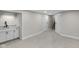 Spacious basement featuring diagonal wood paneling, carpet flooring, wet bar, and access to the stairs at 11035 W Lakeshore Dr, Carmel, IN 46033
