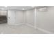 Open basement space featuring carpet flooring, diagonal wood paneling, and stairway access at 11035 W Lakeshore Dr, Carmel, IN 46033