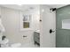 Modern bathroom with a step in shower, green vertical tile accent wall, and undermount sink at 11035 W Lakeshore Dr, Carmel, IN 46033
