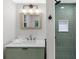 Stylish bathroom features white marble countertop, sink with modern faucet, and green shower tile at 11035 W Lakeshore Dr, Carmel, IN 46033