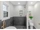 Modern bathroom featuring a tiled shower, toilet, and stylish fixtures, providing a refreshing and functional space at 11035 W Lakeshore Dr, Carmel, IN 46033