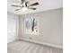 Comfortable bedroom with a ceiling fan, closet, and a bright window at 11035 W Lakeshore Dr, Carmel, IN 46033