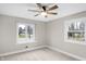 Bright bedroom with a ceiling fan and two windows at 11035 W Lakeshore Dr, Carmel, IN 46033