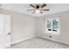 Freshly painted bedroom featuring a ceiling fan and window at 11035 W Lakeshore Dr, Carmel, IN 46033